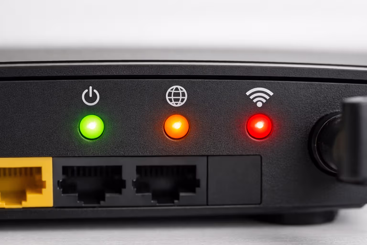 Close-up of router front panel showing multiple LED status indicators in green orange and red colors